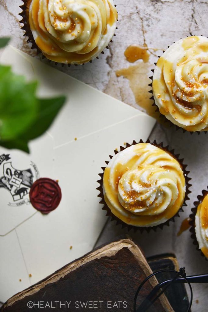 top view of harry potter butterbeer cupcakes with hogwarts letter